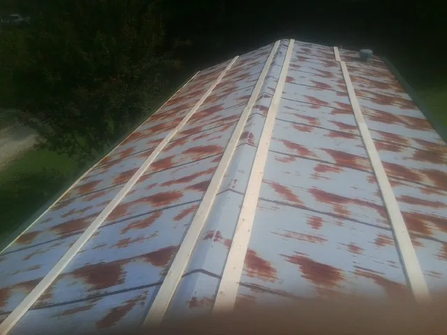Rusted metal roof panels with new wood purlins before replacement — Storm Damage Roof Repair in Mountainville by Roofing Brothers