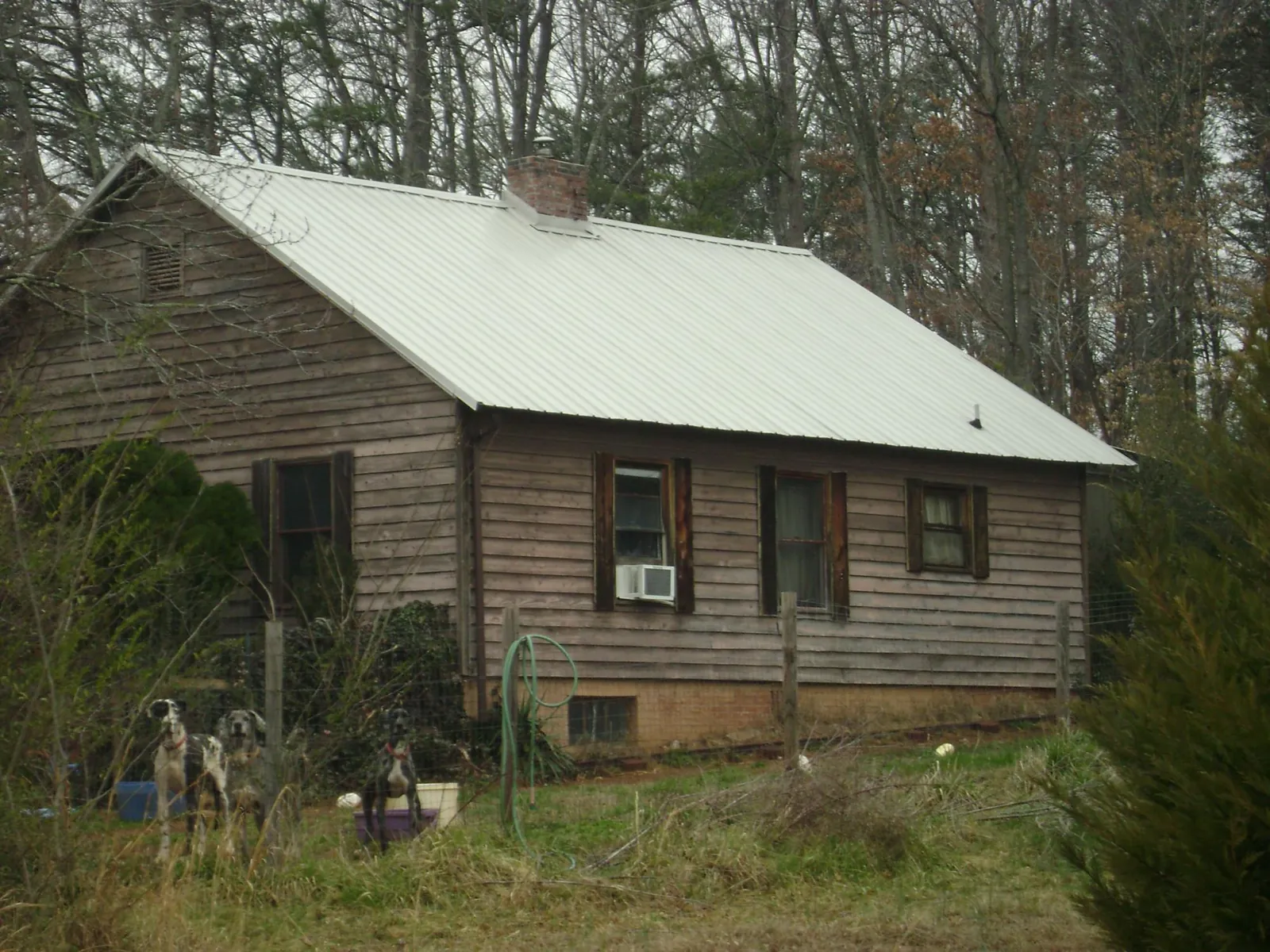 White metal roof on an old wood sided farmhouse, from a Metal Roof Installation job in Mountainville